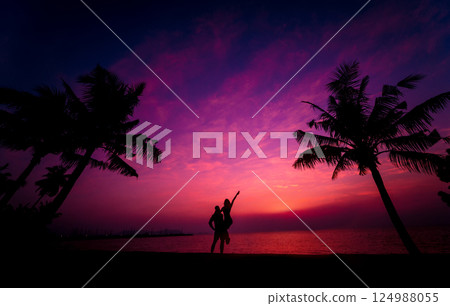 Silhouette of couple on tropical beach during sunset on background of palms Silhouette of couple on tropical beach during sunset on background of palms 124988055