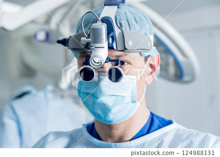 Spinal surgeon in operating room with surgery equipment. Spinal surgeon in operating room with surgery equipment. 124988131