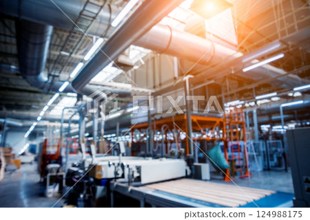 Bloored background of production line of the wooden floor factory. Bloored background of production line of the wooden floor factory. 124988175