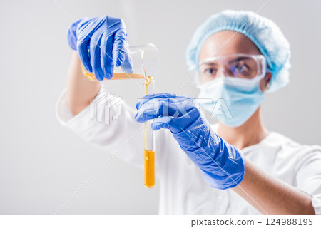 Scientist pouring organic oil. Beauty and cosmetics sciences.  124988195
