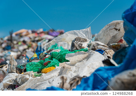Pile of domestic garbage in landfill close up. Environmental pollution. Soft focus Pile of domestic garbage in landfill close up. Environmental pollution. Soft focus 124988268