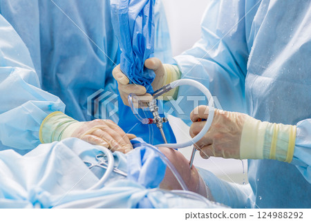 Arthroscope surgery. Orthopedic surgeons in teamwork in the operating room 124988292