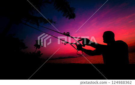 The athlete performs exercises on the beach with fitness straps  124988362