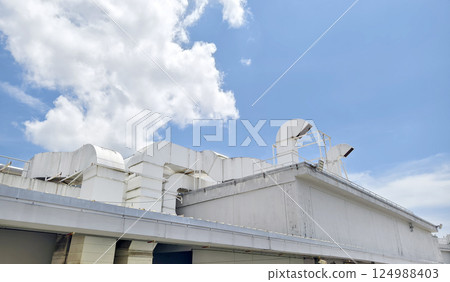 Ventilation pipes on the top of large industrial building 124988403