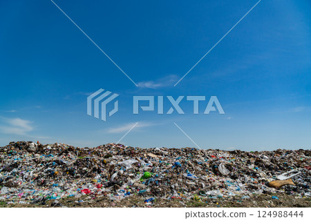 A vast expanse of garbage covers the landfill, showcasing plastic waste and debris under a bright blue sky, emphasizing pollution challenges A vast expanse of garbage covers the landfill, showcasing plastic waste and debris under a bright blue sky, emphasizing pollution challenges 124988444