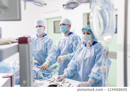Arthroscope surgery. Orthopedic surgeons in teamwork in the operating room 124988608