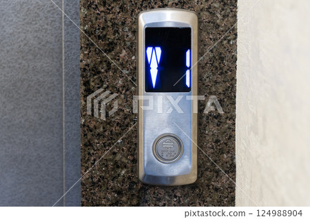 A modern elevator panel shows illuminated floor numbers, blending technology and design in a contemporary urban space A modern elevator panel shows illuminated floor numbers, blending technology and design in a contemporary urban space 124988904