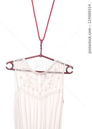 White dress hanging on clothes hanger White dress hanging on clothes hanger 124989314