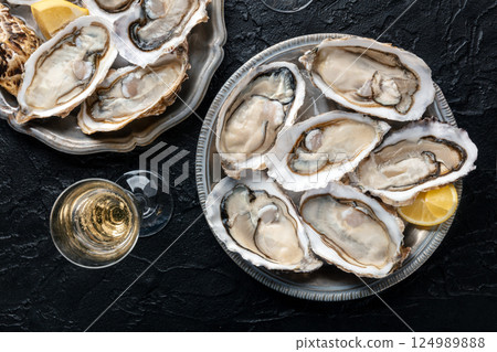 Fresh raw oysters on ice, overhead flat lay shot 124989888