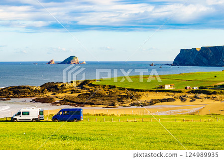 Camper vans on Verdicio beach, Asturias coast in Spain. Camper vans on Verdicio beach, Asturias coast in Spain. 124989935