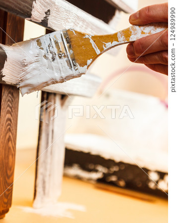 Person renovating wooden hanger Person renovating wooden hanger 124989990