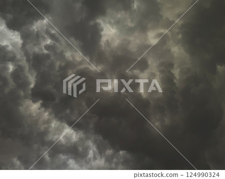 Background image 1 of a charcoal-colored cloudy sky covered with rain clouds 124990324