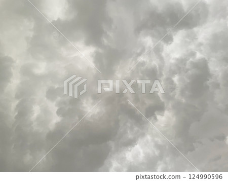 Background image 2 of a dark white-grey cloudy sky covered with rain clouds 124990596