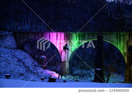 Winter illumination of Megane Bridge in Tono 124990809