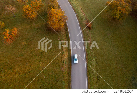 Aerial view with winding road in an autumn scenery at sunrise 124991204