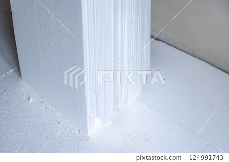 Close-up of extruded polystyrene foam insulation creating a thermal barrier in building construction 124991743