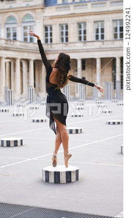 Graceful Ballerina on Pointe in Paris Courtyard by Elegant Architecture Graceful Ballerina on Pointe in Paris Courtyard by Elegant Architecture 124992241