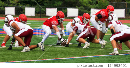 High School Football Teams Starting a New Play on a Turf Field High School Football Teams Starting a New Play on a Turf Field 124992491