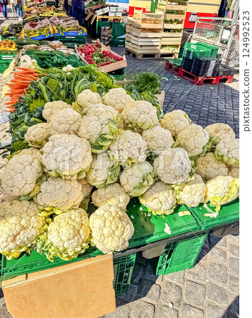 Fresh cauliflower and assorted vegetables at outdoor farmers market stall. High quality photo Fresh cauliflower and assorted vegetables at outdoor farmers market stall. High quality photo 124992523