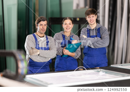 Two men and woman working in glass factory Two men and woman working in glass factory 124992550