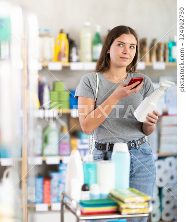 Woman scanning package with spray 124992730