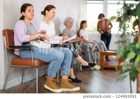 Young woman waiting for her turn on chair 124993091