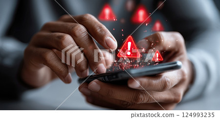person typing on mobile phone with red warning icons floating above, symbolizing online threats 124993235