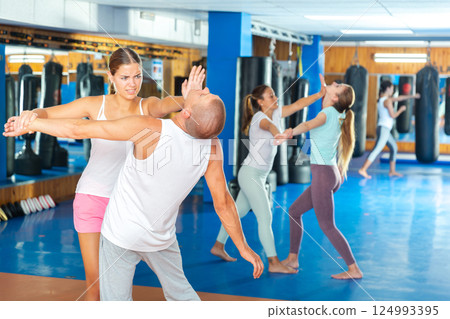 Young woman exercising chin strike 124993395