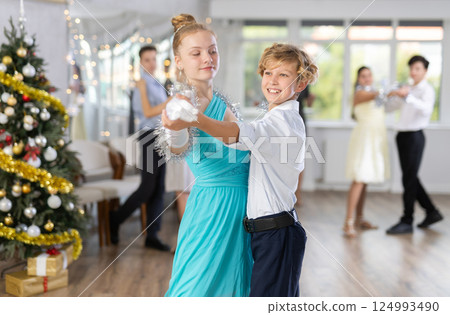 Boy and girl dancing waltz in studio 124993490