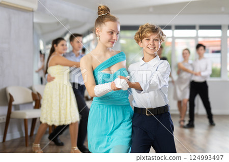 Boy and girl dancing waltz in studio Boy and girl dancing waltz in studio 124993497