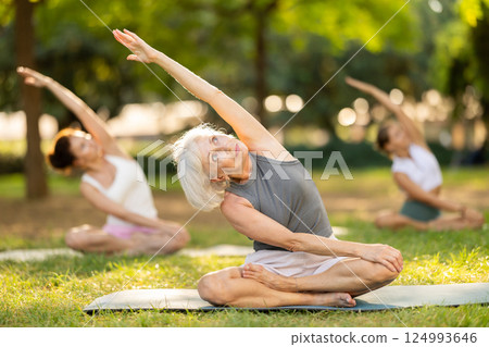 Elderly woman doing yoga in lotus position Elderly woman doing yoga in lotus position 124993646