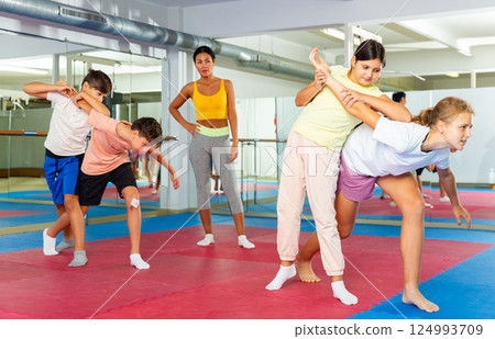 Young boys and girls learning self-protection moves 124993709
