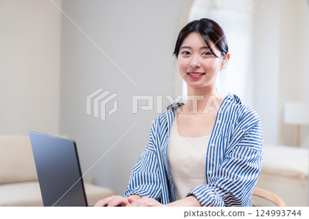 Smiling young woman participating in a remote meeting at home 124993744