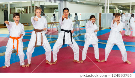 Teenager children wearing karate uniform fighters poses 124993795