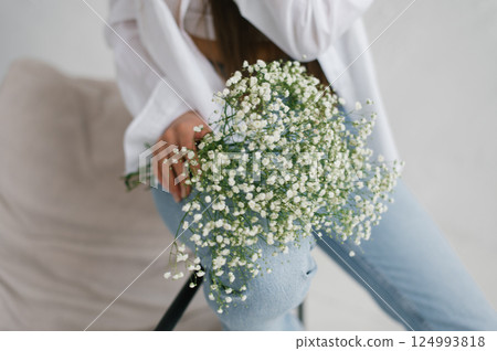 Woman Holding White Gypsophila Flowers 124993818