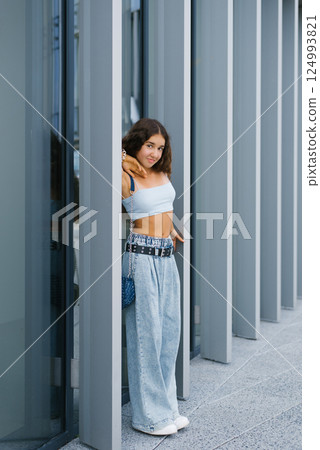 Smiling Girl Posing By Columns 124993821