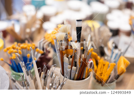 Brushes and tools for sculpting in ceramic workshop 124993849