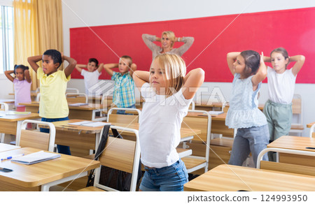 Gymnastics in classroom in elementary school 124993950