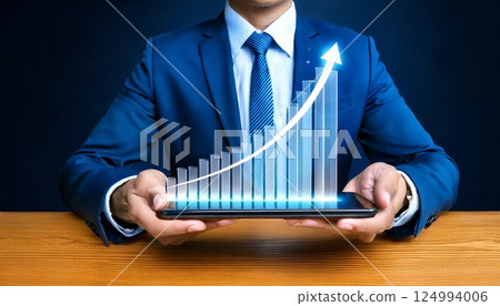 Success in the digital age: Future-oriented business strategies as seen in an upward graph held by a businessman 124994006