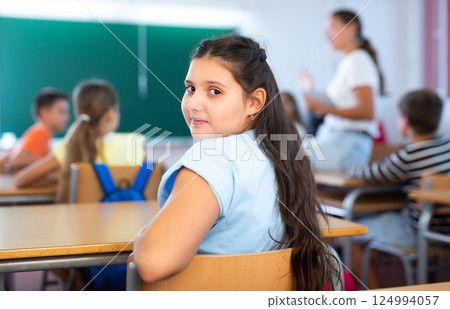 Portrait of girl in classroom during lesson Portrait of girl in classroom during lesson 124994057