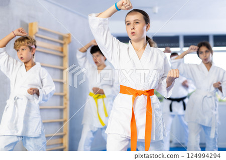 Group of children train karate techniques 124994294