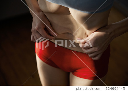 Woman sunken belly and anorexic skinny body 124994445