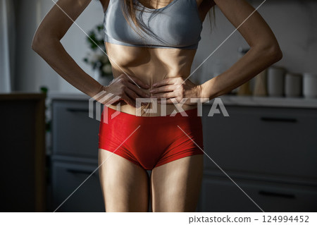Midsection shot of woman sunken belly and anorexic skinny body Midsection shot of woman sunken belly and anorexic skinny body 124994452