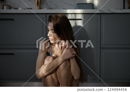 Depressed woman feeling emotional pressure and stress suffering from anorexia 124994456