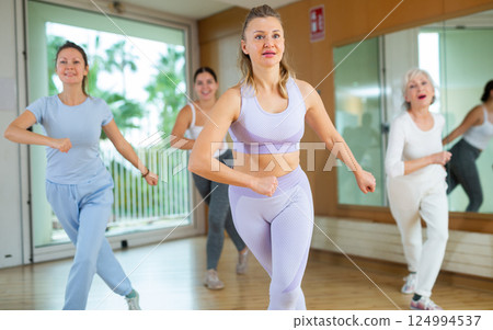 Positive people practicing vigorous lindy hop movements in dance class Positive people practicing vigorous lindy hop movements in dance class 124994537