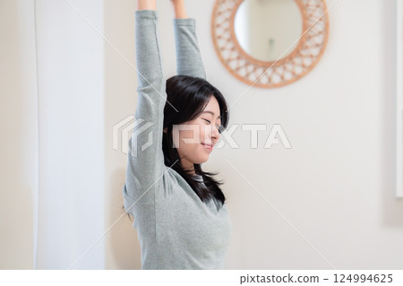Young woman waking up in bed Young woman waking up in bed 124994625