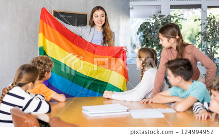 Teacher showing transgender flag to group of schoolchildren Teacher showing transgender flag to group of schoolchildren 124994952