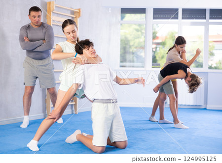 Boy and girl practicing self-defense techniques Boy and girl practicing self-defense techniques 124995125