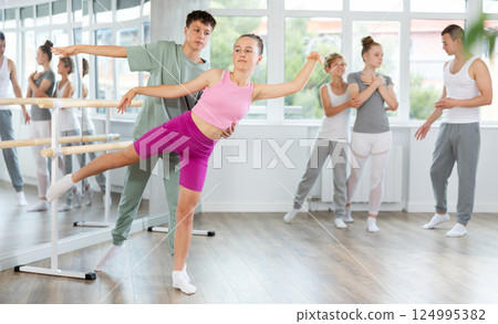 Ballet training for teenagers in a ballet studio under the guidance of choreographer Ballet training for teenagers in a ballet studio under the guidance of choreographer 124995382