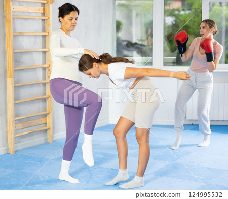 Women train to deliver striking blows and defend themselves in process of self-defense Women train to deliver striking blows and defend themselves in process of self-defense 124995532